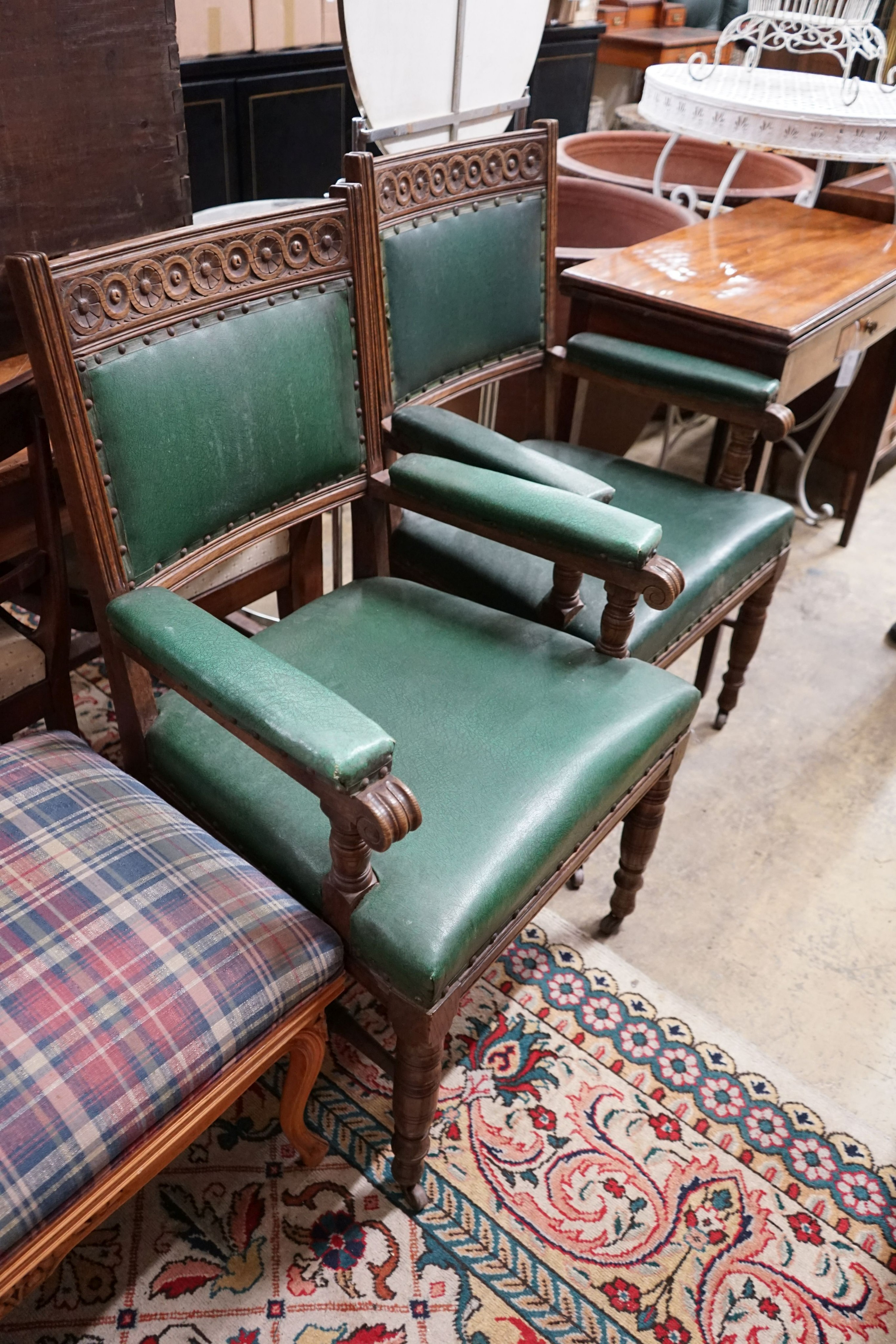A pair of late Victorian carved oak elbow chairs, width 60cm, depth 53cm, height 100cm
